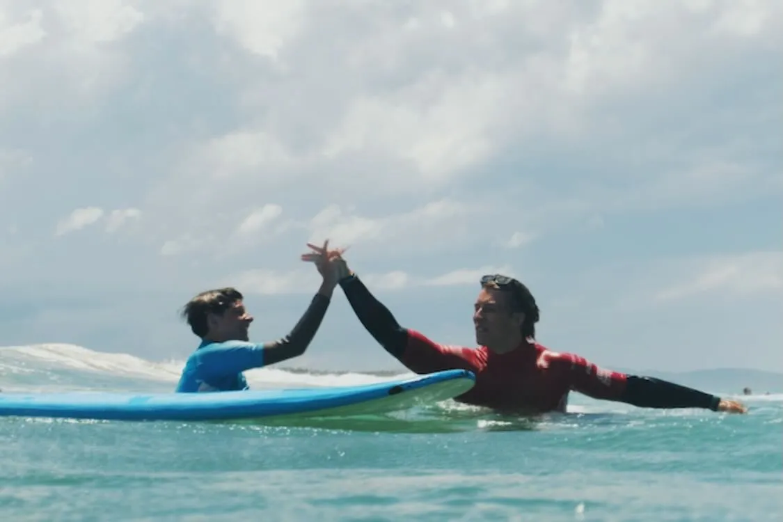 High five in the water after a wave well ridden