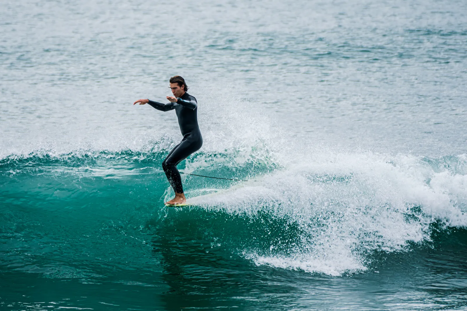 Adult surfer carving a clean green wave