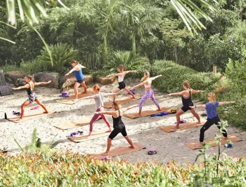 Beach yoga session at the womens wellness retreat