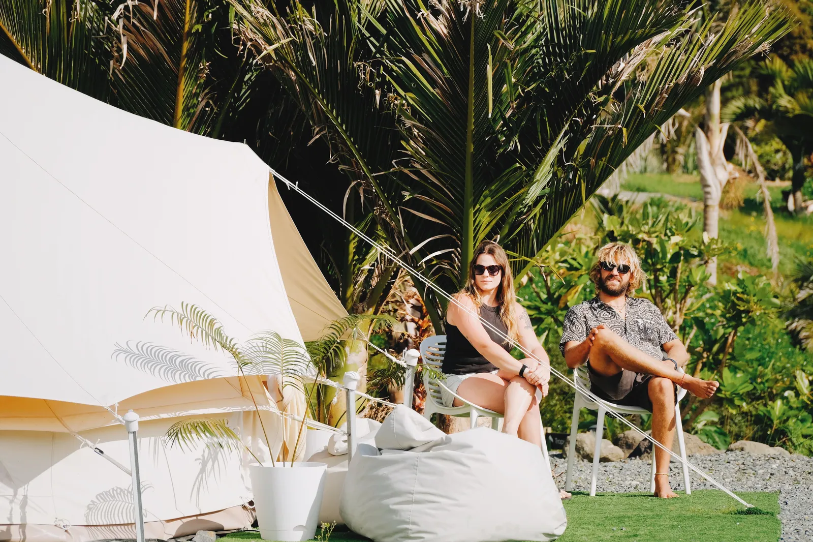 Couple lounging in the sun at the glamping site
