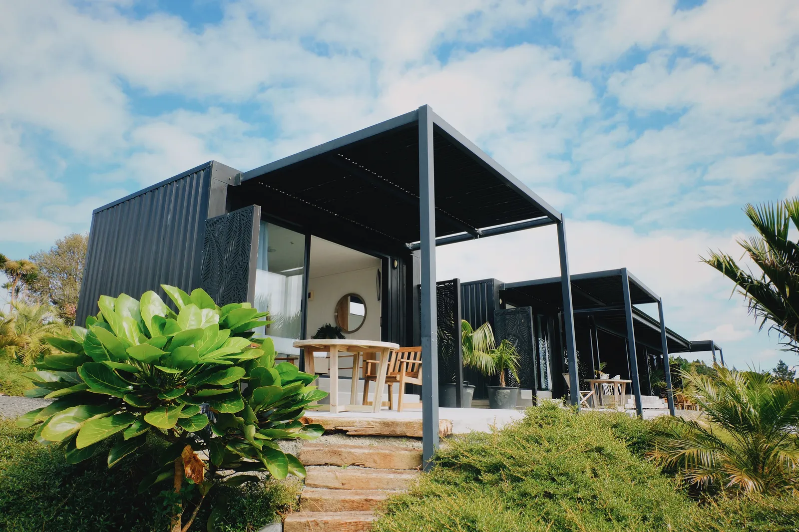 Eco pod nestled in greenery at Te Arai