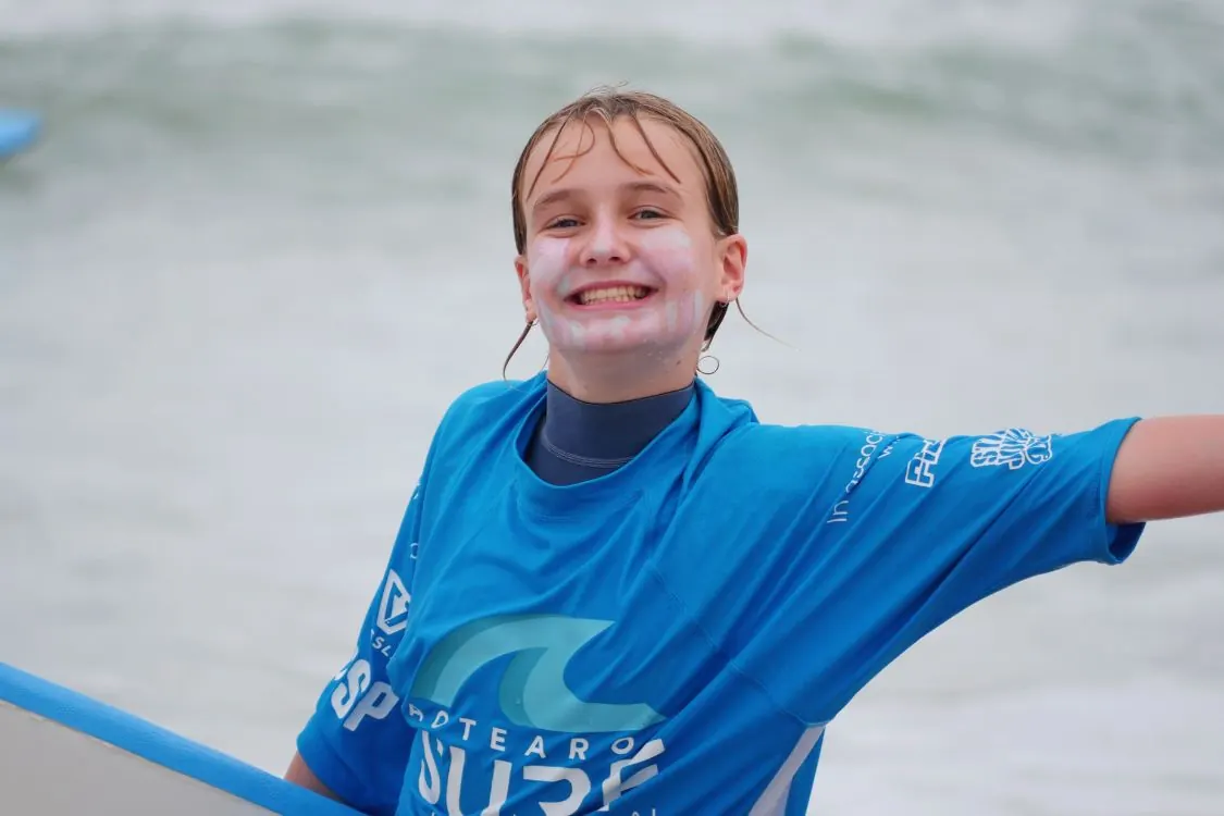 Holiday program surfers heading out at a Christchurch beach