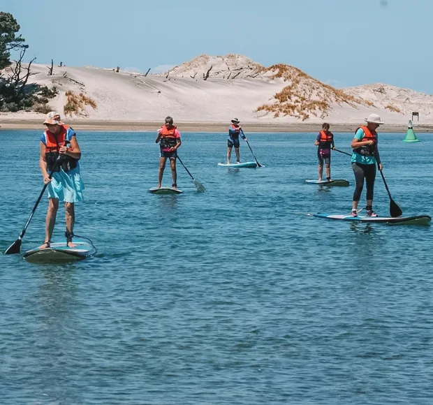 SUP and kayak crew on the water in the afternoon