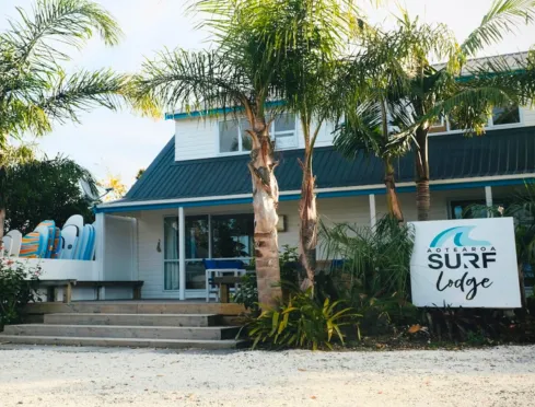 Mangawhai Surf Lodge behind its palms in the village