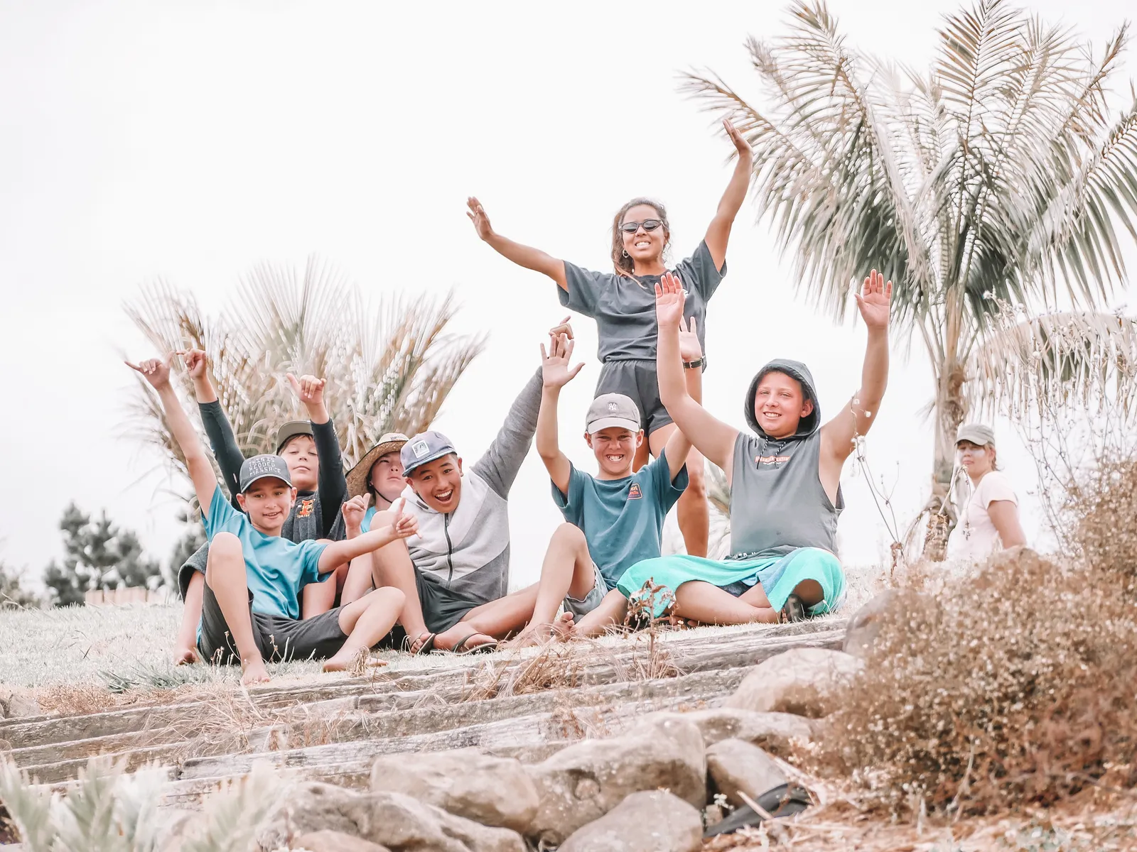 Camp crew on the driftwood at the beach