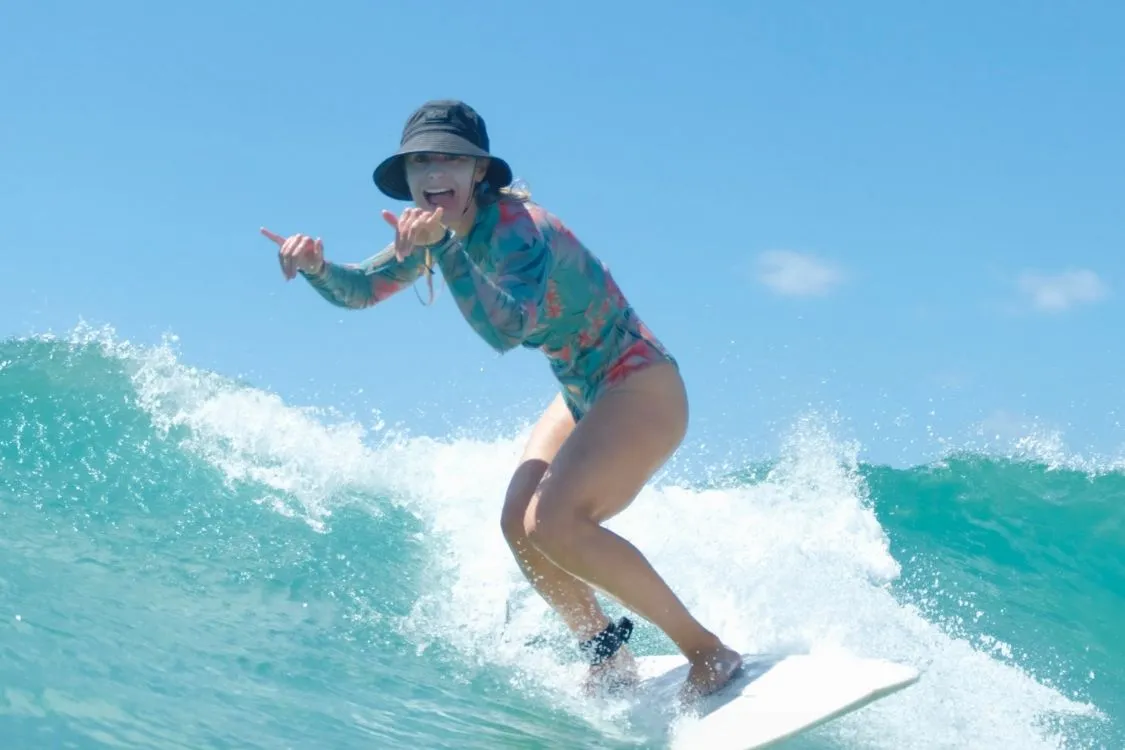 Teen surfer trimming down a clean wave